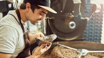 Barista an einer Kaffeeröstmaschine