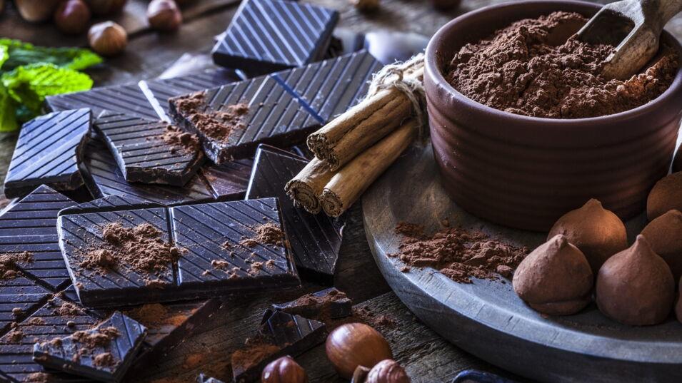 Schokolade mit Kakaopulver und Zimt auf Tisch