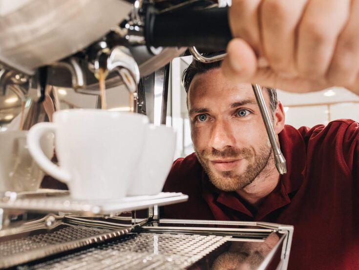 A technician from Kaffee Partner observes making two cups of coffee.