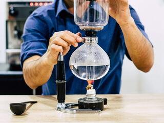 Kaffee-Syphon: Wasser im Glaskolben zum Kochen bringen